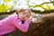 Blond children kid girl having a nap lying on a tree