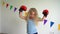 Blond curly hair girl with boxing gloves posing looking at camera. slow motion