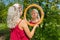 Blond dutch woman looks at mirror in nature
