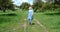 Blond european woman walking in the garden wearing and taking off original face mask