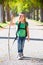 Blond explorer kid girl walking with backpack in autumn trees