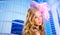 Blond fashion girl with pink hat in blue skyscrapers