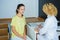 Blond female doctor talking to patient in the hospital