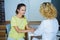 Blond female doctor talking to patient in the hospital