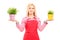 A blond female gardener holding two potted plants