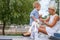 Blond female in white dress and her cute little child.