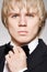 Blond gentleman in elegant black suit with bow-tie