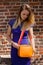 Blond girl blue dress orange handbag, Groot Begijnhof, Leuven, Belgium