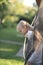 Blond girl comes out from the protective net of the trampoline