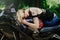 The blond girl lies on a motorcycle, smiles eyes, sensual and cheerful, hair closes her eyes