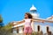 Blond girl open hands in Mediterranean Lighthouse