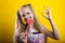 Blond girl with ponytails eats lollipop