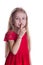 Blond girl in red dress putting finger up to lips saying shhh