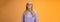 Blond girl show teeth warn can stand herself bite, fool around grimacing funny wearing purple hoodie glasses standing