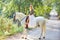 Blond girl woman riding a white horse in track