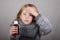 Blond hair little girl holding cough syrup in a hand. Sick child.. Child winter flu health care concept