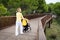 Blond hair woman strolling a baby in carriage