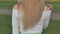 Blond hair of a young blonde with a standing back.