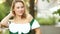 Blond happy bavarian woman smiling in a dirndl. The girl is smiling, looking at the camera, flirting, shows the neckline