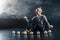 Blond juggler sitting on the floor with white balls on black background