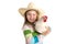 Blond kid girl farmer holding white hen on arms