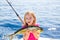 Blond kid girl fishing Dorado Mahi-mahi fish happy catch