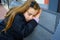 Blond kid girl pretending being sleep on bench