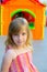 Blond kid girl smiling in outdoor playground