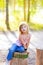 Blond kid girl in tree trunk forest