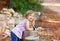 Blond kid girl in tree trunk forest