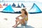 Blond kite surf teen girl in summer beach sitting