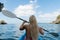 Blond Lady in the kayak in  calm tropical bay Thailand sea