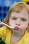 Blond little girl eating and gesturing