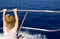 Blond little girl rear view sailing in boat