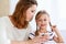 Blond little reading together with mom