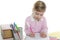 Blond little student girl writing desk