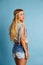 Blond long hair girl with jeans shorts summer look