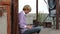 Blond man sits on a construction place and works at his laptop