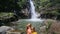 Blond Mother Little Daughter Go into Pond by Waterfall Base
