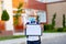 A blond schoolboy with glasses and a protective mask stands at the school and holds a sign with a white sheet. Day of knowledge.