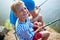 Blond Smiling Boy Fishing with Dad