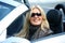 Blond smiling woman in a car