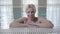 Blond smiling woman posing at poolside. Portrait of happy young Caucasian lady resting in spa in luxury hotel. Wealth
