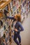 Blond student picking book from bookshelf