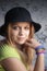 Blond teenage girl in black hat and rubber loom bracelets