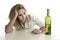 Blond wasted and depressed alcoholic drunk woman drinking white wine glass desperate sad