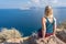 Blond woman admiring landscape of Santorini caldera