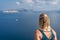 Blond woman admiring landscape of Santorini caldera