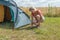 Blond woman is building outdoor tent