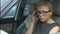 Blond woman in eyeglasses sitting in car and feeling terrible headache, migraine